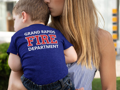 Close-up of the back of the toddler's bodysuit featuring the custom fire department name in red text on navy blue fabric