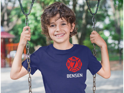 Child wearing the personalized firefighter birthday t-shirt, showcasing the front design with the red Maltese Cross and custom details