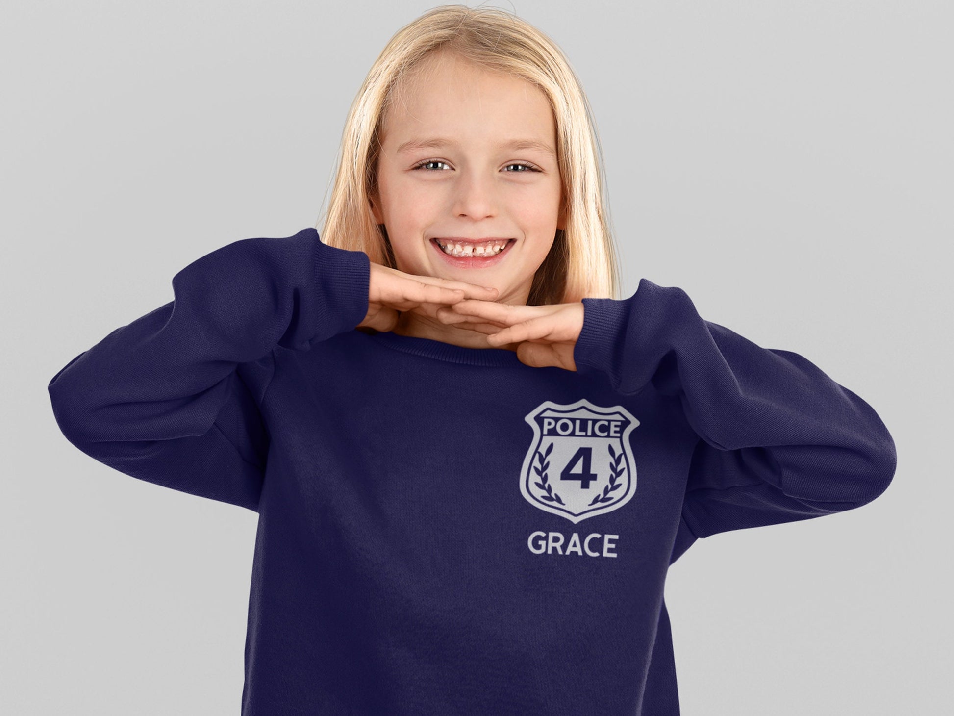 A navy blue sweatshirt with a silver police badge design. The badge has the text 'POLICE' and the number '4' inside. The text 'GRACE' is below the badge.