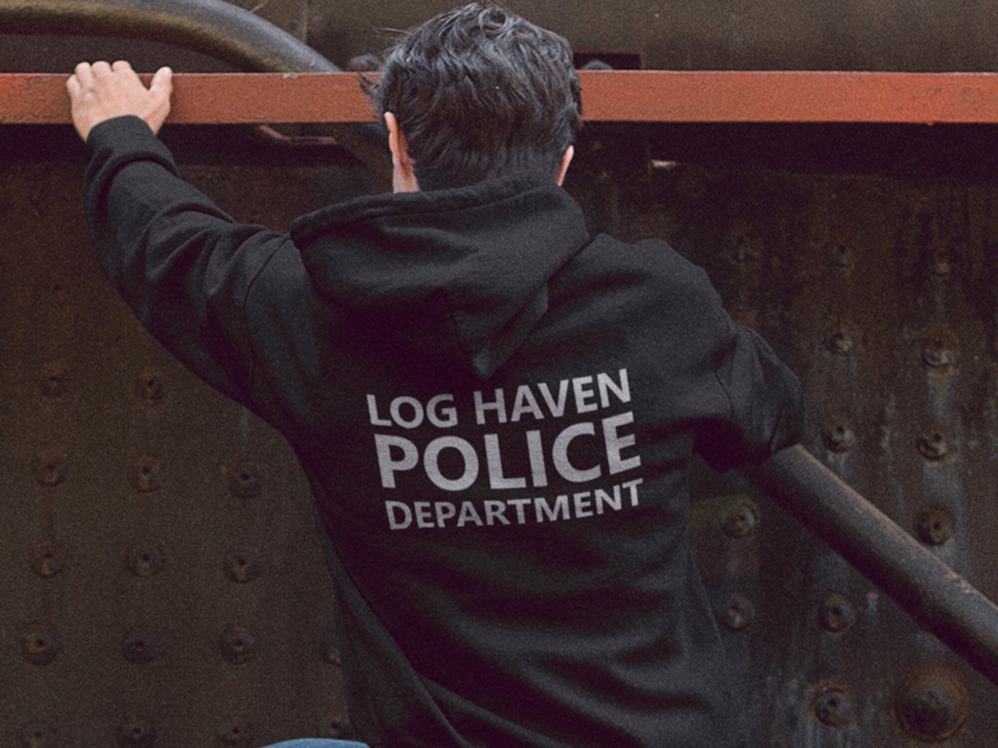 Black hooded sweatshirt with the text 'LOG HAVEN POLICE DEPARTMENT' in silver print on the back. The sweatshirt is a pullover style with a drawstring hood.