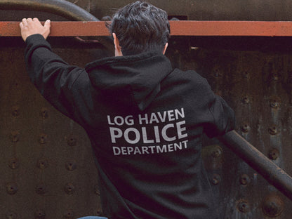 Black hooded sweatshirt with the text 'LOG HAVEN POLICE DEPARTMENT' in silver print on the back. The sweatshirt is a pullover style with a drawstring hood.