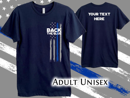 A navy blue t-shirt with a thin blue line American flag design and the text 'Back the Blue' on the front. The back of the shirt has the text 'Your Text Here'. The shirt is labeled 'Adult Unisex'.