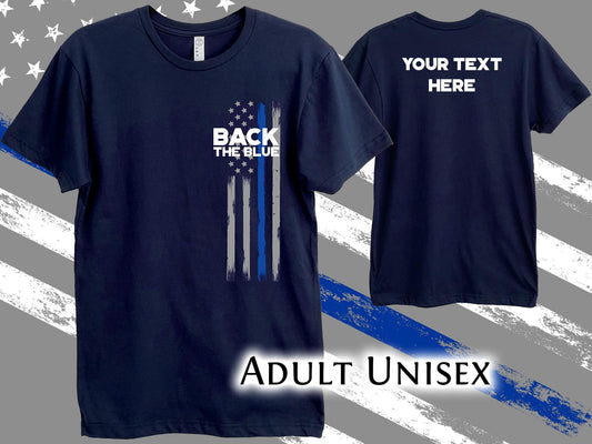 A navy blue t-shirt with a thin blue line American flag design and the text 'Back the Blue' on the front. The back of the shirt has the text 'Your Text Here'. The shirt is labeled 'Adult Unisex'.