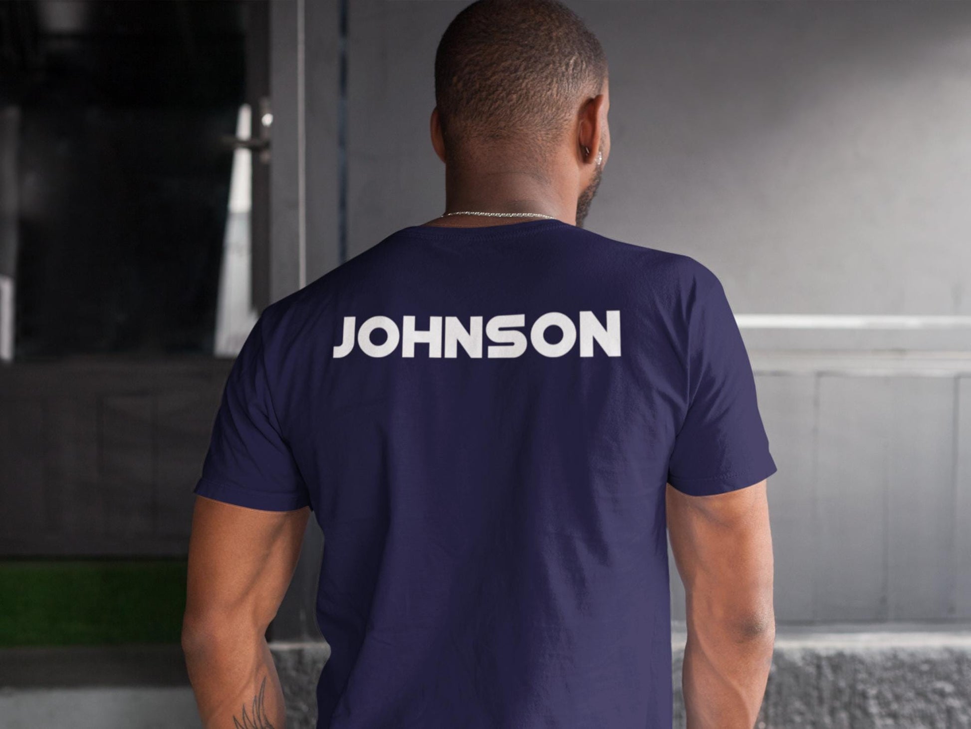A navy blue t-shirt with the word 'JOHNSON' printed in white on the back.