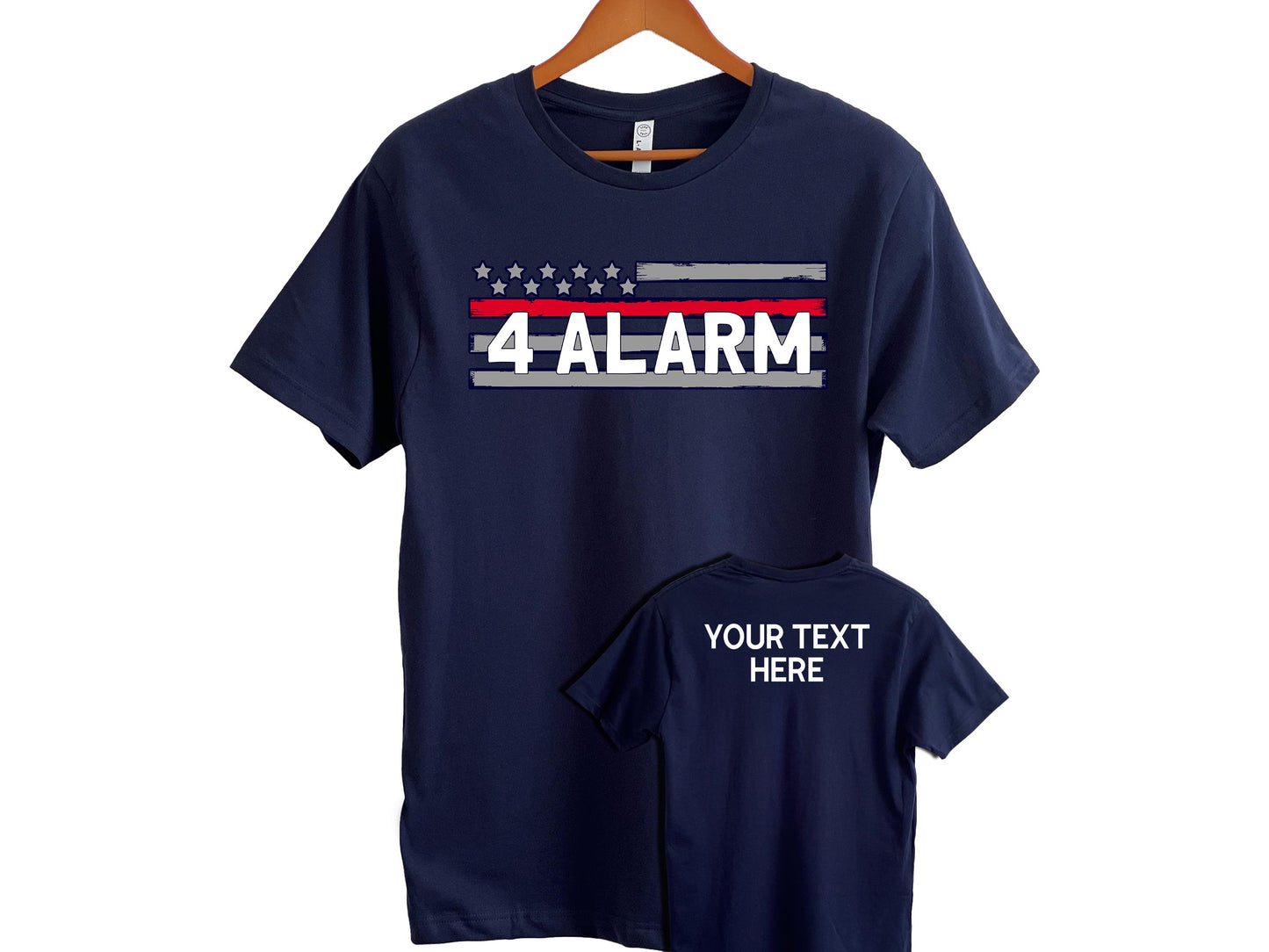 Navy blue t-shirt with a distressed American flag design on the front, featuring gray, red, and blue stripes, stars above, and bold white text that reads “4 ALARM” which can be personalized with custom text. A smaller image shows the back of the shirt with customizable placeholder text “YOUR TEXT HERE.” A great tribute shirt for firefighters or fire service supporters.