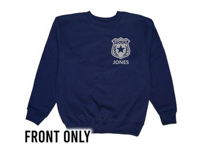 A navy blue youth sweatshirt with a silver police badge design on the front. The badge has a star and the words 'POLICE' and 'DILLON'  is written underneath in silver text.