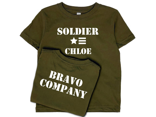 Army green short sleeve t-shirt with 'Soldier' in white text, a star and 3 horizontal stripes underneath, and under that the name 'Chloe'. The shirt back reads 'Bravo Company' in white text.