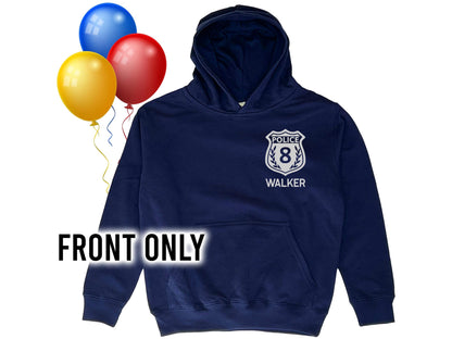 Front view of the personalized police birthday hoodie showing the white badge with custom number and name on navy blue fabric