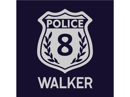 Close up detail of police badge with name underneath in silver on navy fabric