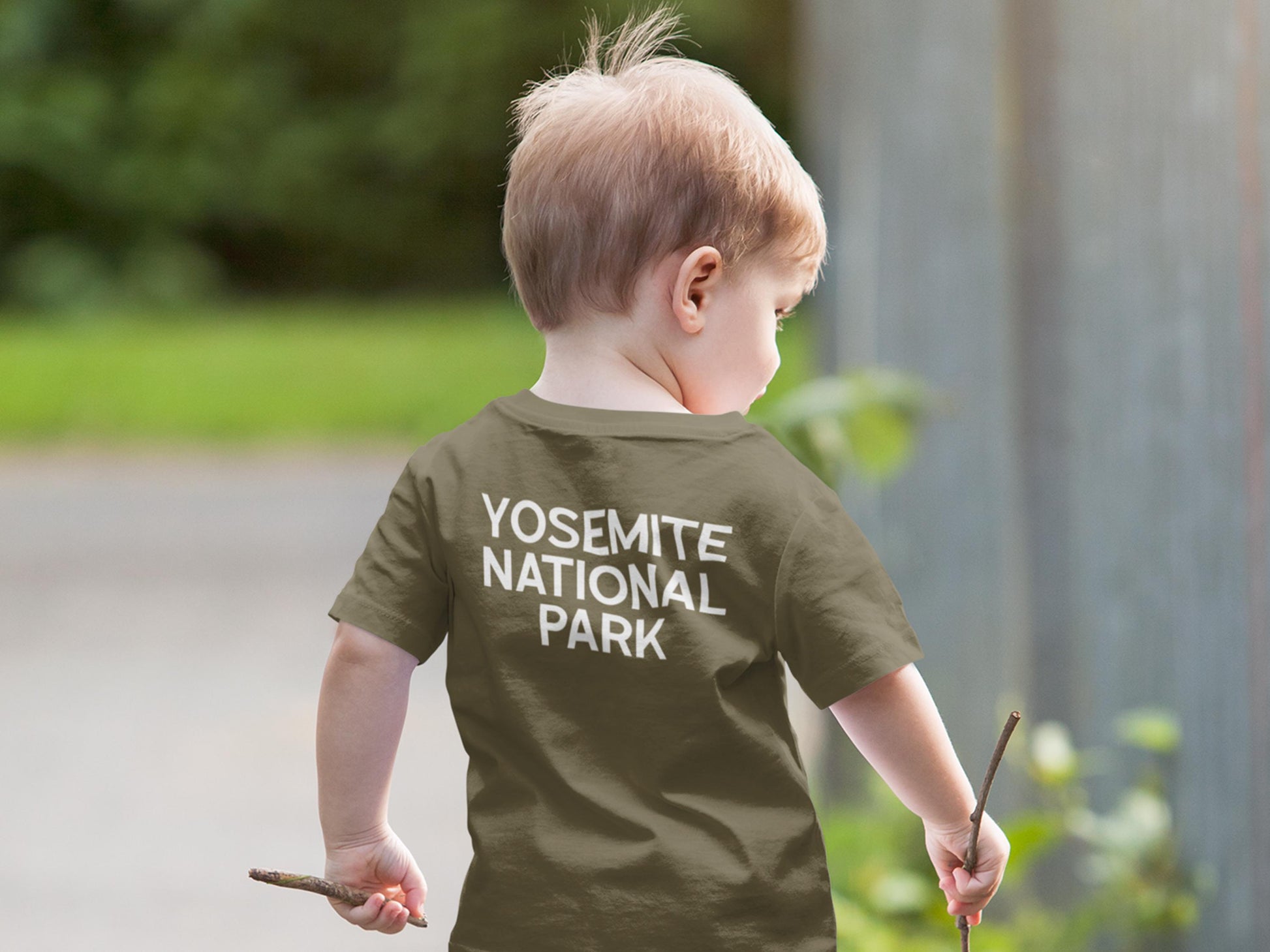 A child wearing a dark green t-shirt with the text 'Yosemite National Park' in white lettering.