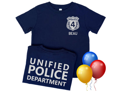 Navy blue kids police t shirt with silver police badge on left chest displaying the custom age of child and custom name underneath. Back of shirt with custom police department in silver text.