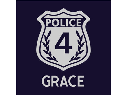 Close up detail of silver police badge with number '4' in the center and laurel leaves on the sides on a navy blue background. The name 'Grace' is underneath.