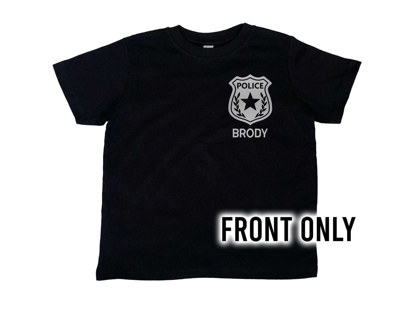 Front view of black t-shirt with silver police badge on left chest and the name 'Brody' underneath in silver text.