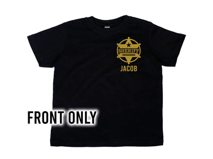 Front view of a black toddler tee with a gold sheriff's badge on left chest and the name "Jacob" underneath as a placeholder for custom name.