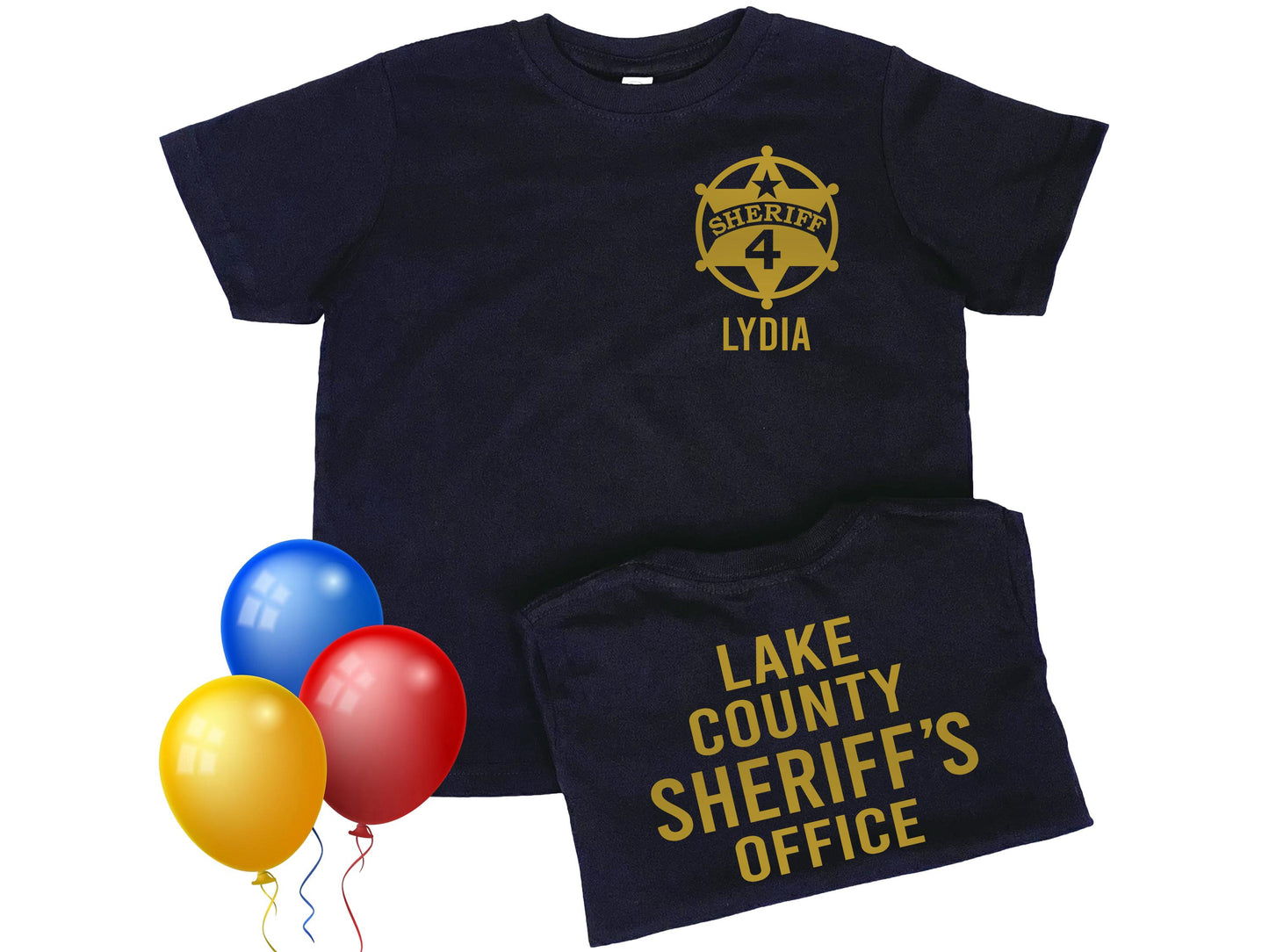 Toddler black t-shirt with told star sheriff badge on the left chest. Badge contains the number 4 in the center and the name 'Lydia' underneath as placeholders for child's name and age. The back of the shirt says 'Lake County Sheriff's Office' in gold lettering.